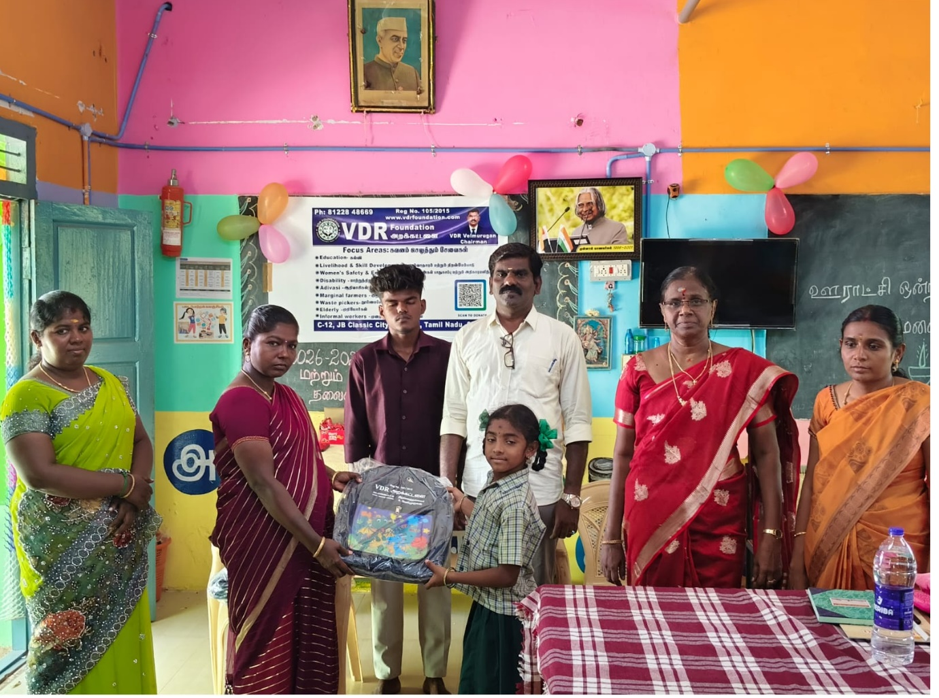 Volunteers distributing school bags